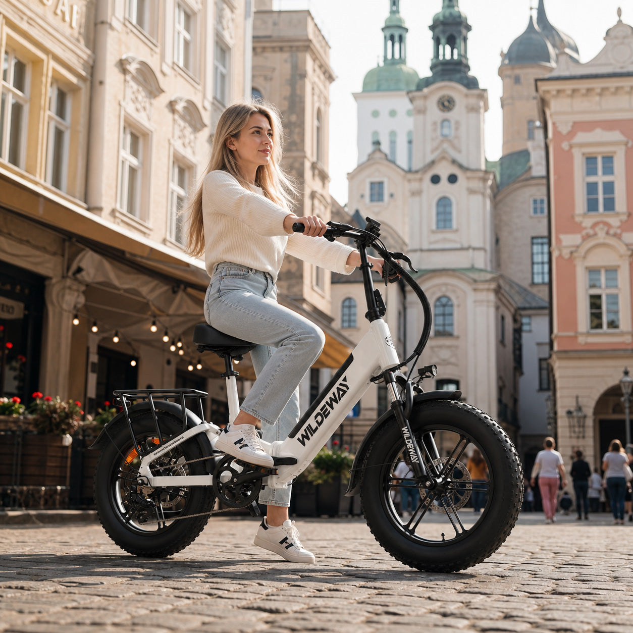 Wildeway Torpedo full suspension folding fat tire e-bike on a European cobblestone street, designed for comfort, city riding, and compact storage.