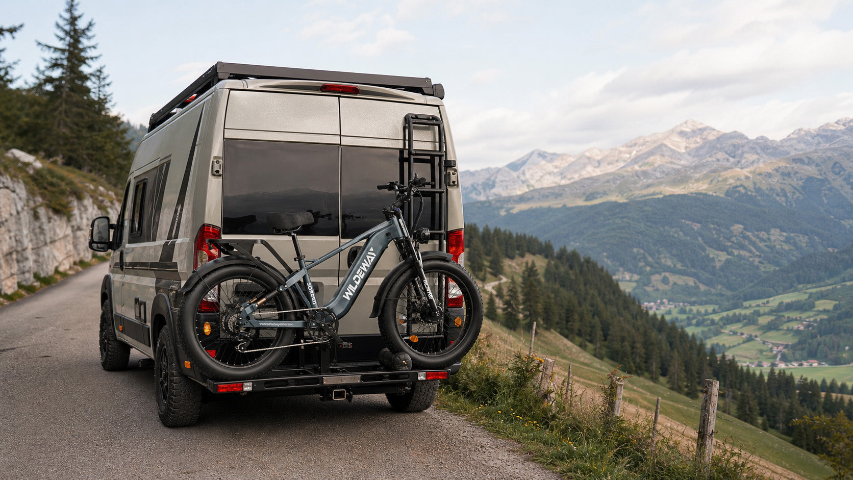 A WILDEWAY SOARED heavy-duty fat tire e-bike securely loaded onto a car towball rack using a loading ramp for easy transport